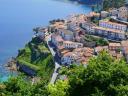 View from above of a fishing village on a cliff with the sea in the background