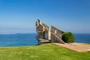 A modern viewpoint with views of the Cantabrian Sea and a blue sky