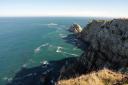 Spectacular aerial view of rugged cliffs and the blue sea of the Asturian coast