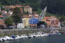A fishing port with moored boats and colorful buildings