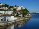 Stepped white houses overlook the estuary and are reflected in it