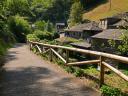 A path with a wooden railing in a traditional village with slate roofs