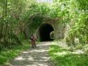 Cyclist in front of the via verde tunnel in Lloreu