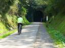 Cyclist entering a tunnel on the via verde de la Camocha Gijon