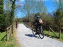 Cyclist cycling along the river park in Gijon