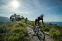 Cyclists on mountain bikes along the coast of Llanes
