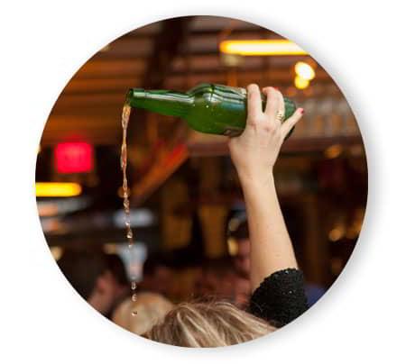 Cider pouring where you can see the bottle pouring the cider.