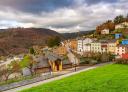 General view of Santalla with traditional dwellings and autumnal mountain surroundings.