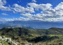 Mountain scenery with clouds and clear skies over green peaks