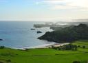 Coastal landscape with cliffs and green meadows next to the Cantabrian Sea.