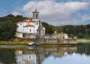 Church of Niembro reflected in the estuary by the cemetery
