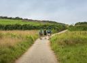 Pilgrims walking along the green path between Poo and Celorio