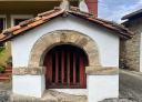Small white chapel with a red roof at Cimiano