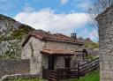 Traditional red-roofed hut among limestone rocks