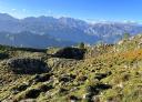 Rock formations and green slopes on the ascent to Turbina Peak