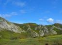 Panoramic view of slopes and valleys with peaks in the background