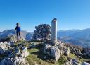 Group of hikers walking towards Ibeu peak with the Picos in the background.