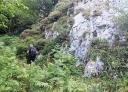 Hiker entering the Palombar Gorge on a narrow path.