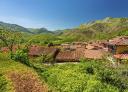 Campiellos surrounded by green mountains under clear skies