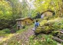 Stone mills surrounded by forest on the Corroriu route