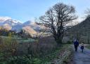 Family walking along the road with mountains in the background