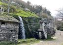 Traditional mill with waterwheel and waterfall in Os Teixois
