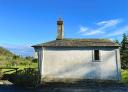 Small white chapel with belfry in rural setting