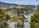 Panoramic view of Castropol from the estuary with wooded islet in the foreground.
