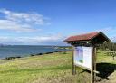 Information panel of the Arnao area with the sea in the background.