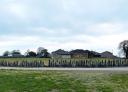 Stone enclosure in a castro with trees and cloudy sky