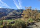 Wide panoramic view of the Ibias valley with mountains and autumn vegetation.