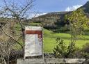 Route information sign at the beginning of Boal, with mountain scenery.