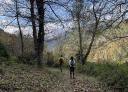 Couple of hikers walking through the forest parallel to the Muniellos river.
