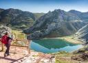 Viewpoint with hikers overlooking a mountain lake and craggy peaks