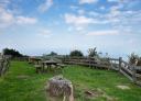 Recreation area with picnic tables and wooden railing with sea views
