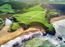 Aerial view of the beach, green coastline and rock formations