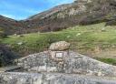 Stone fountain in a clear mountain landscape