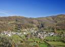 Panoramic view of a mountainside village surrounded by nature.