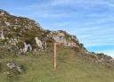 Wooden signpost marking the top of the peak at 1,300 metres