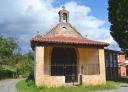 Small stone chapel with belfry in a sunny rural setting