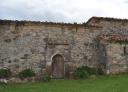 Romanesque stone church with arched doorway and sturdy walls