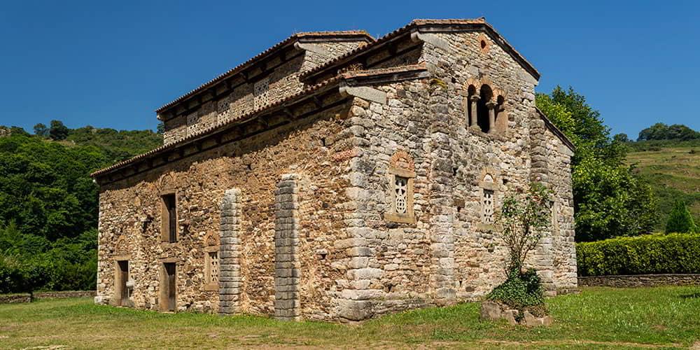 San Pedro de Nora, an example of Asturian pre-Romanesque architecture, with its buttresses and stone structure.