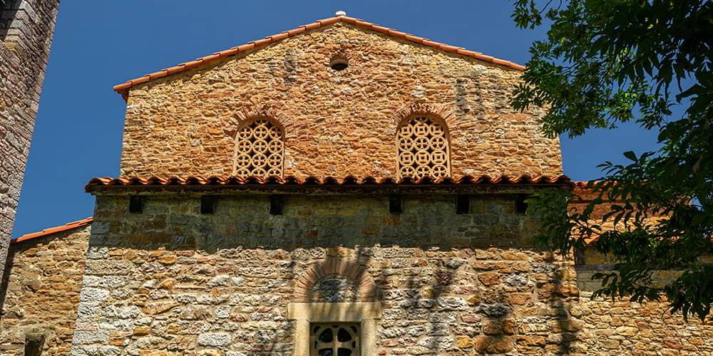 The pre-Romanesque church of Santa María de Bendones in Oviedo/Uviéu, showing its latticed windows.