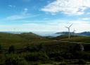 Landscape of the Sierra del Carondio with wind turbines on the horizon.