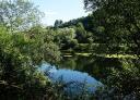 Wide panoramic view of the river Nalón, reflecting the sky and the vegetation.