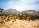 View of a mountain peak covered with dry vegetation on a cloudy day.
