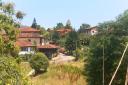 View of the houses in the village of San Román among the trees.