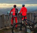 Two cyclists admiring the views of the mountains at the Següencu viewpoint
