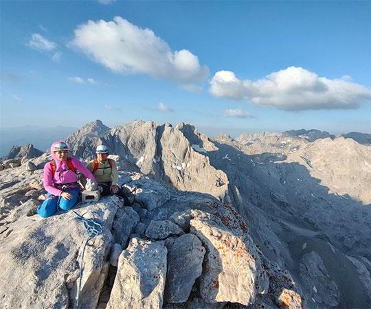 Photo of a climbing couple at the top of a mountain