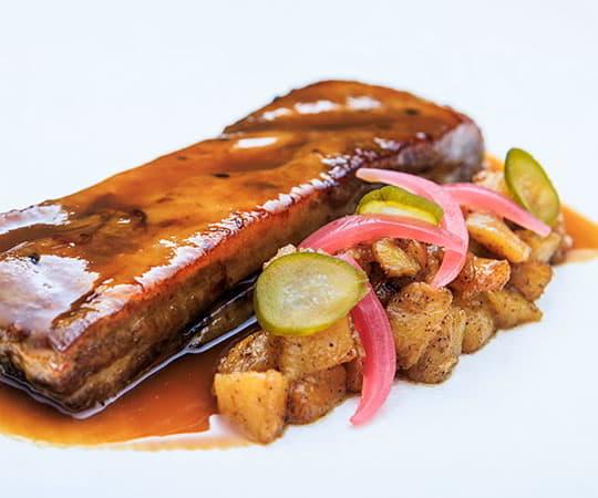 Dish of a rib with garnish.